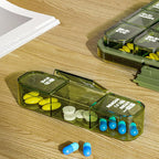 The weekly pill organiser held in hand, demonstrating its practical size for easy portability.