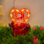 Decorative couple statue in heart-shaped frame with rose base