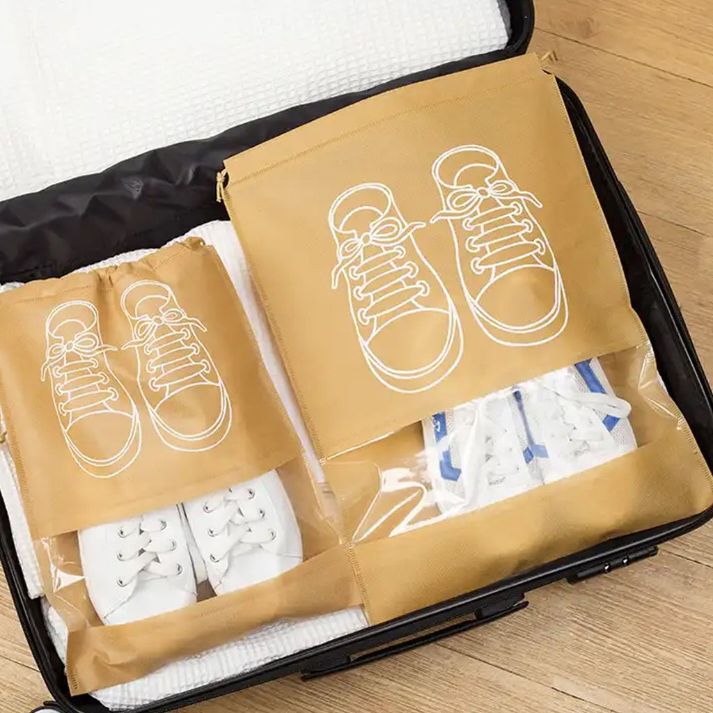Organivo waterproof shoe bag with beach essentials storage on a sandy beach.