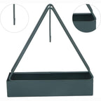 Mosquito coil holder placed flat on an outdoor patio table with greenery.