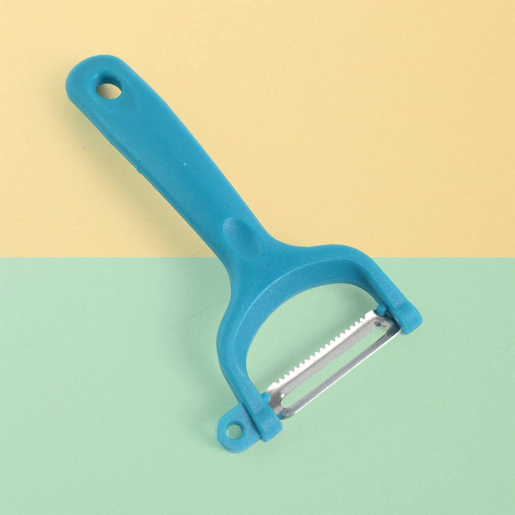 The serrated blade of the vegetable peeler shown up close.