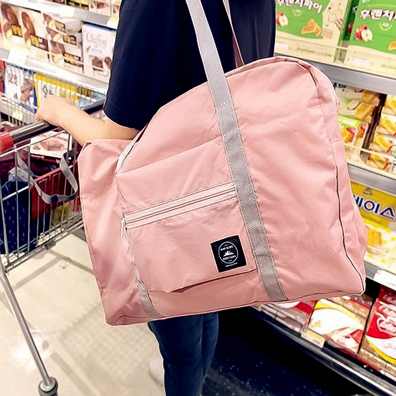 Side view of the blue travel bag, highlighting its sturdy handles and robust design.