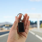 Sleek rectangular metal keychain with polished black and silver edges