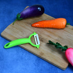 A hand demonstrating the precise slicing of vegetables using the ceramic utility knife.