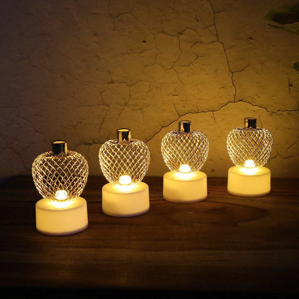 Apple LED tealight candles arranged on a festive backdrop for Diwali decor.