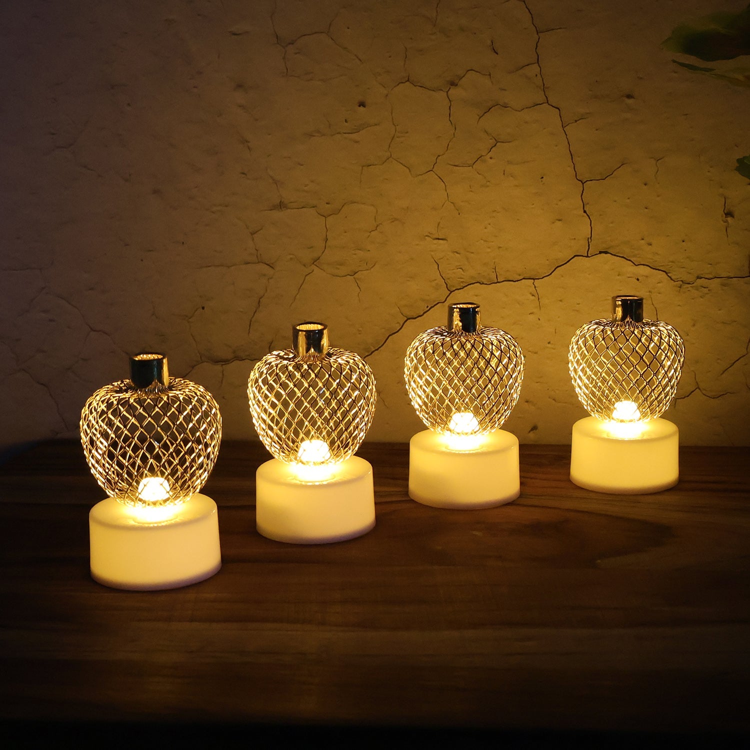 Apple LED tealight candles arranged on a festive backdrop for Diwali decor.