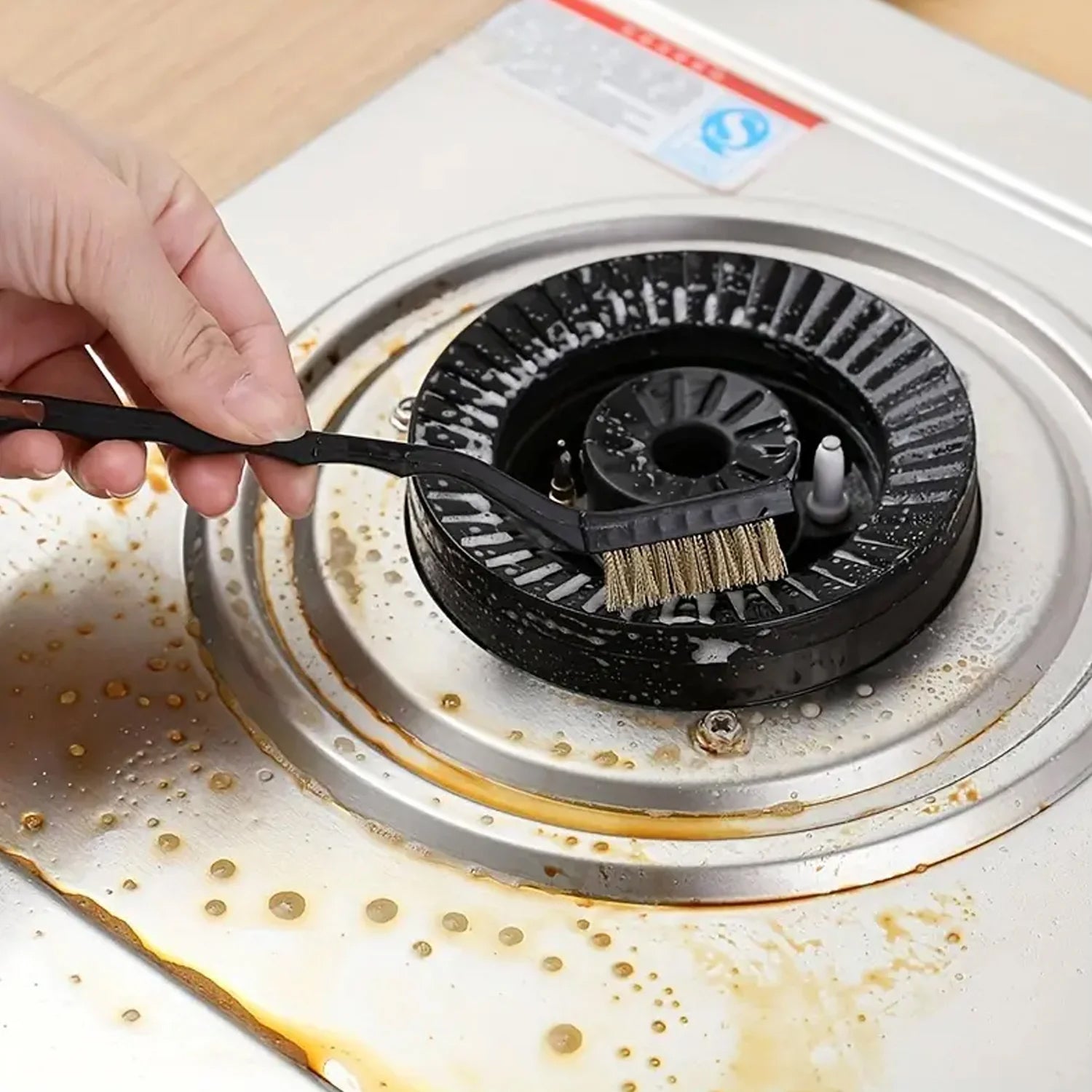 Hand holding a brass wire brush demonstrating its comfortable grip for cleaning.