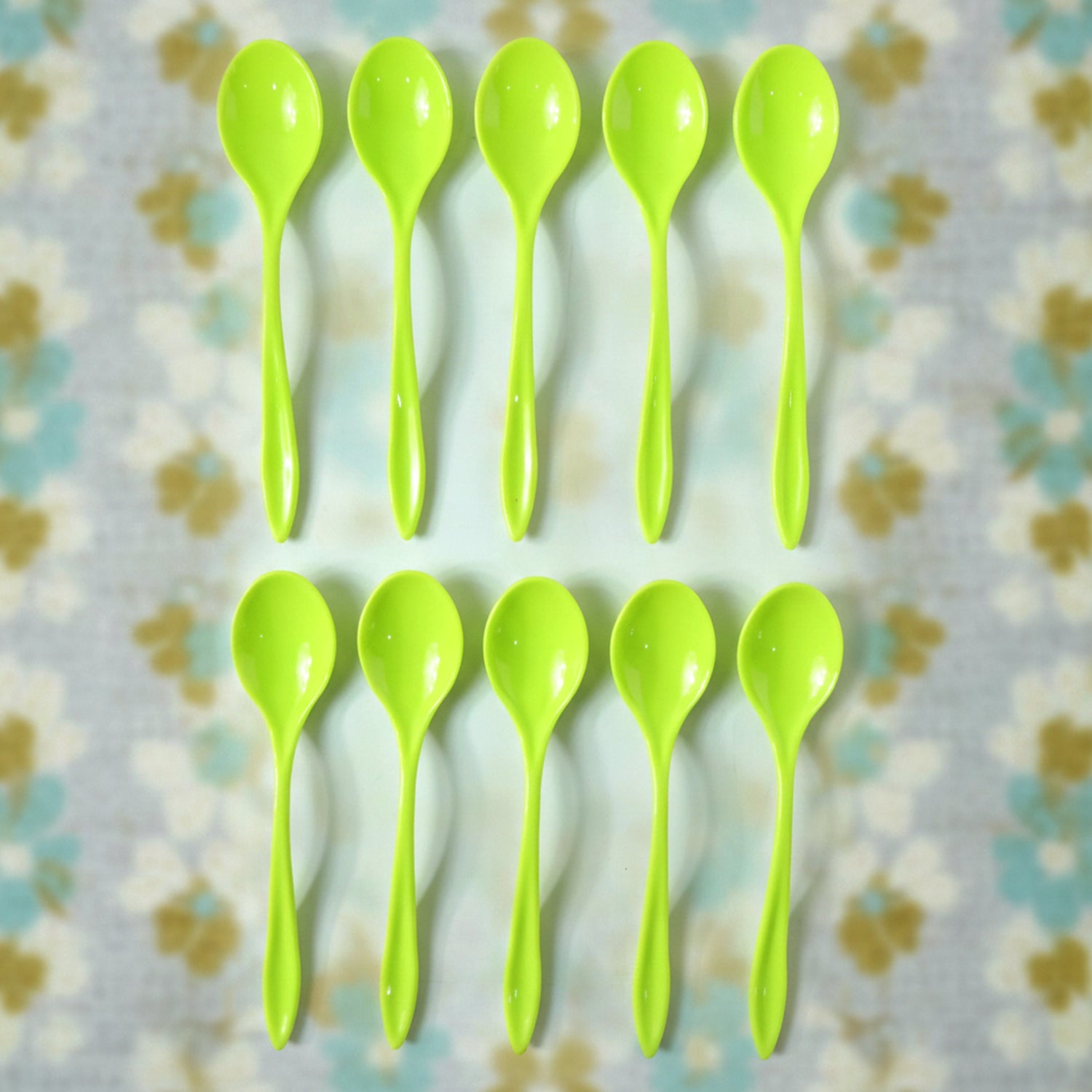 A single reusable plastic spoon placed elegantly on a table setting.