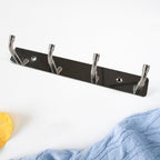 Wall mounted stainless steel hook rack used in entryway for coats and keys