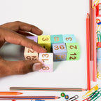 Various wooden number and symbol pieces from the Aditi educational math game.