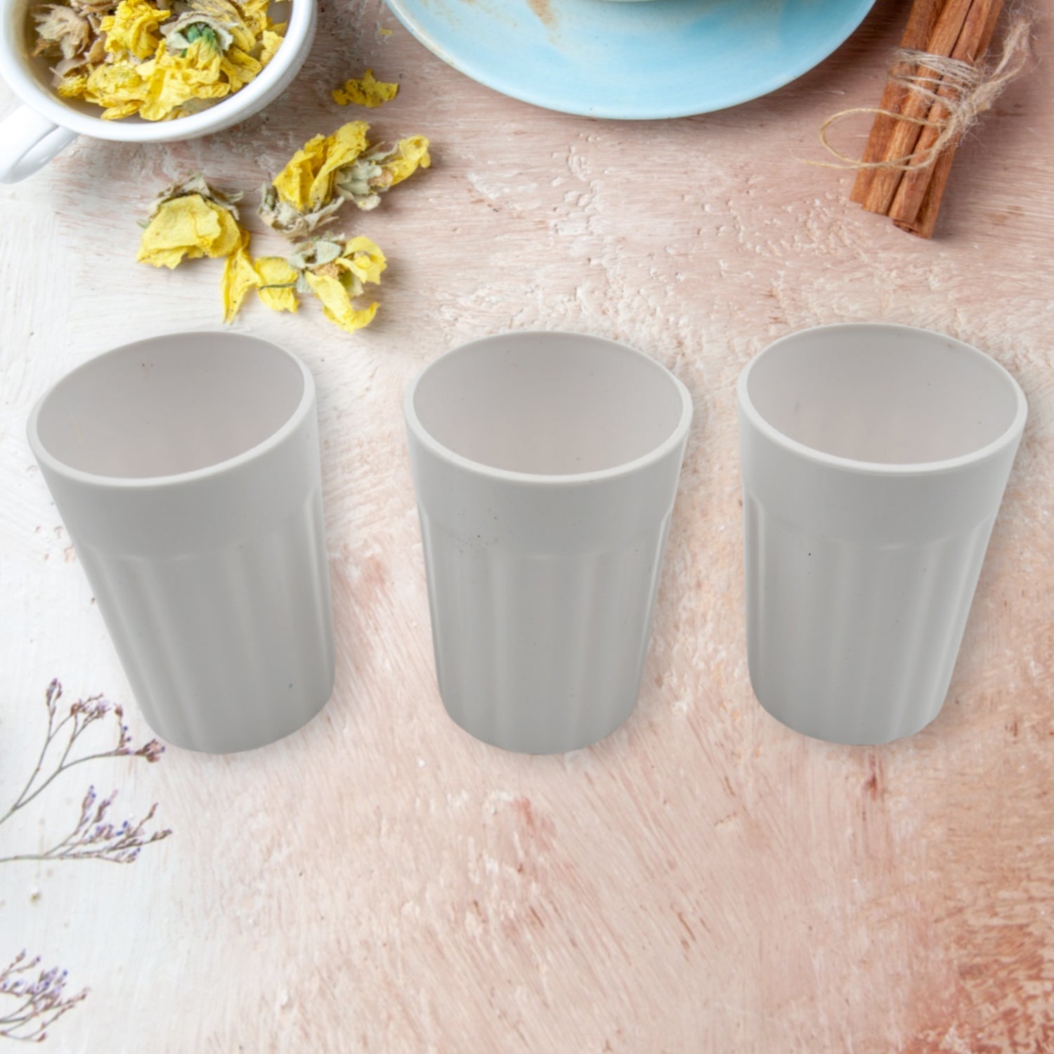 Side view of a single unbreakable plastic tea cup on a clean background.