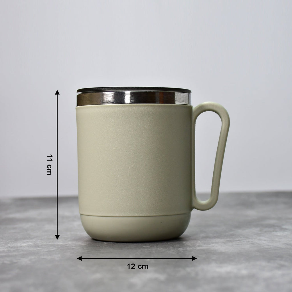 An Indian man enjoying a hot beverage from the Ganesh stainless steel coffee mug.
