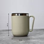An Indian man enjoying a hot beverage from the Ganesh stainless steel coffee mug.