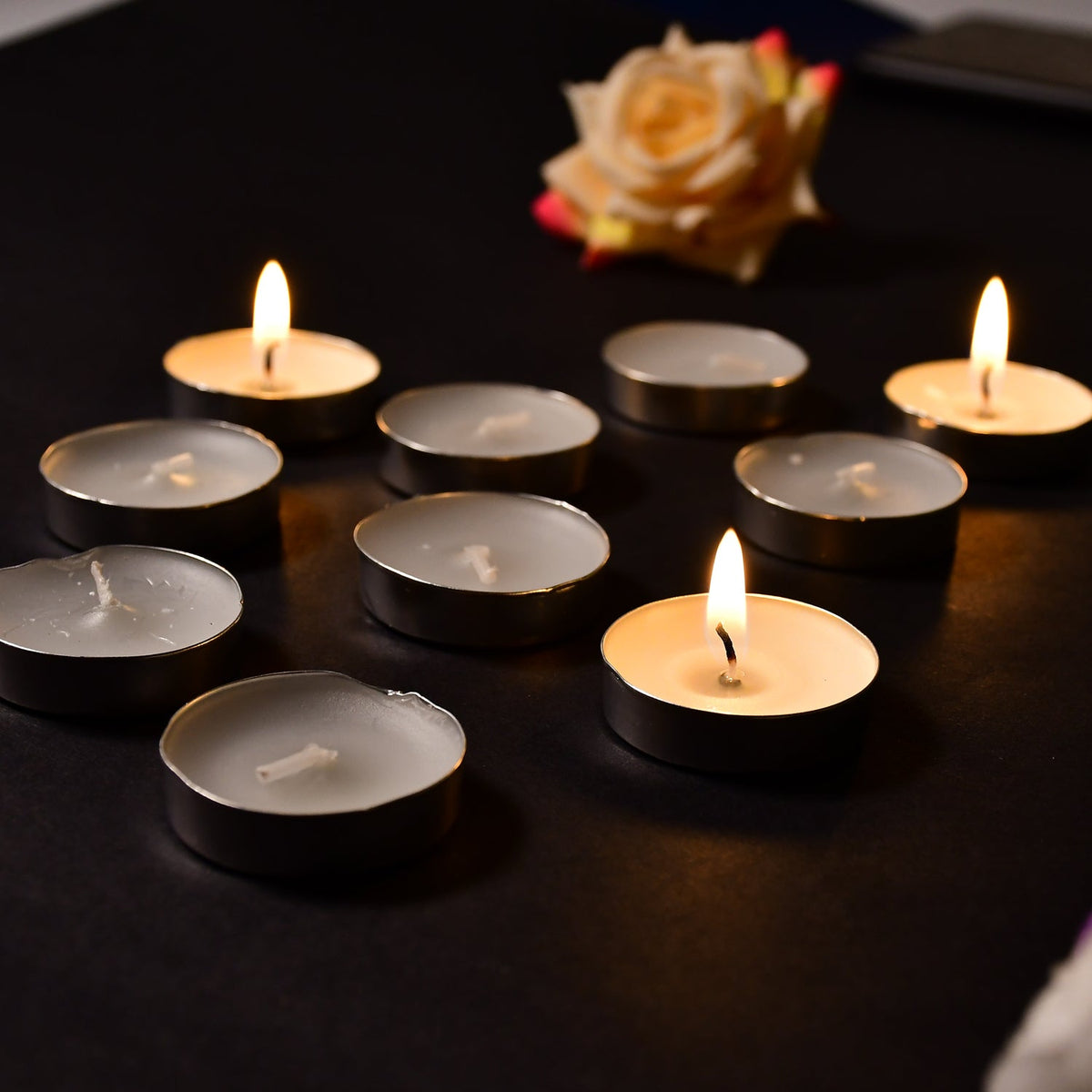 Variety of colorful decorative candles arranged, adding a festive touch to any room.