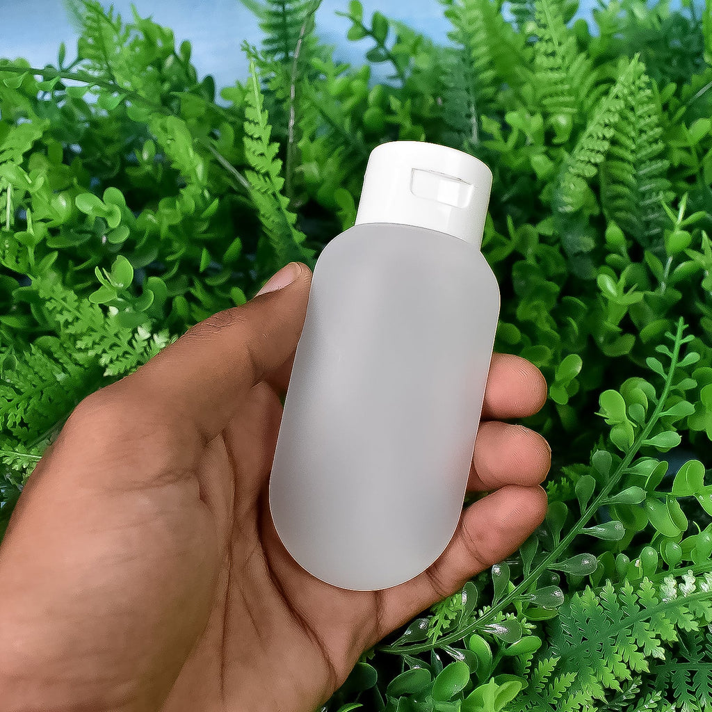 Nomad brand 60ml travel bottles filled with various toiletries, demonstrating their practical use.