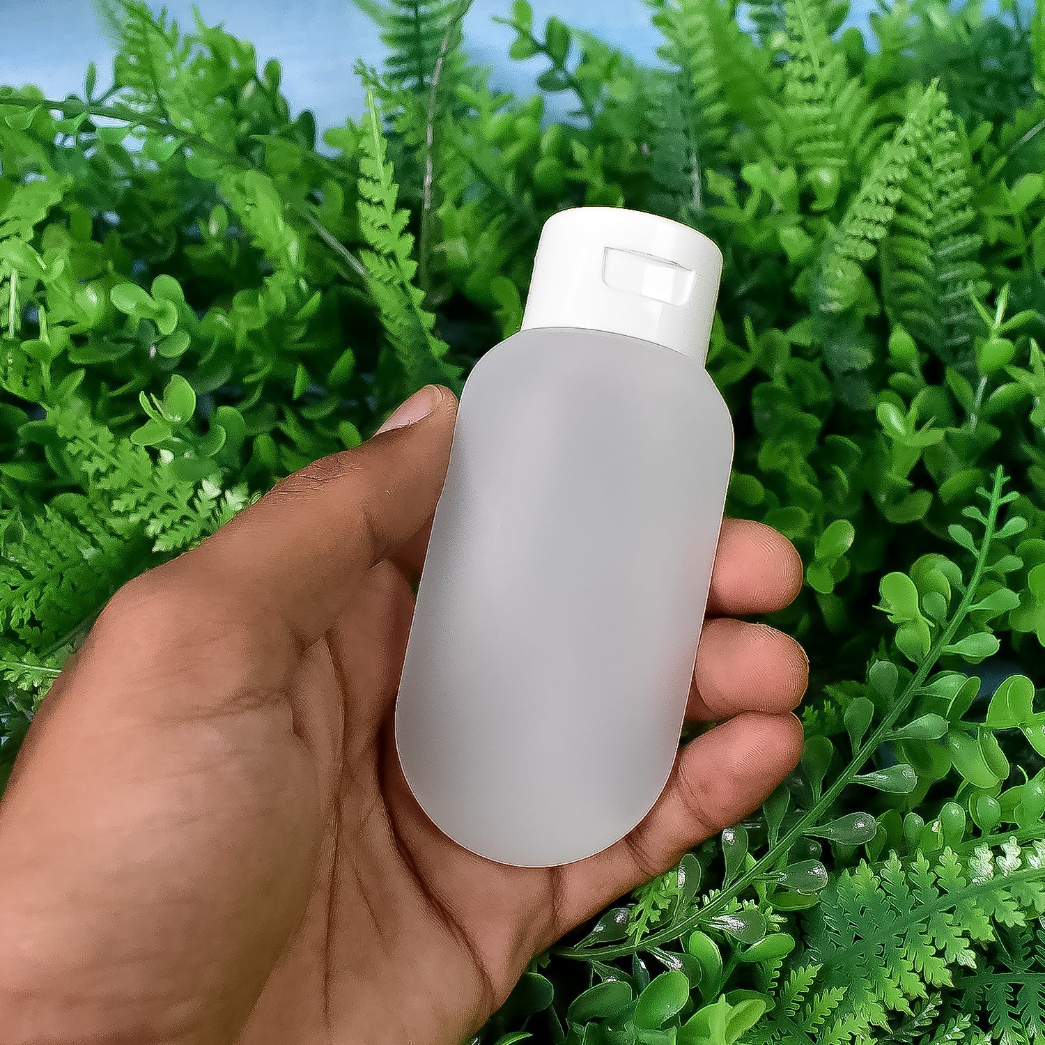 Nomad brand 60ml travel bottles filled with various toiletries, demonstrating their practical use.