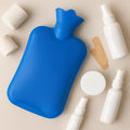 A red Hot Water Bag 1400ML providing soothing warmth for pain relief.