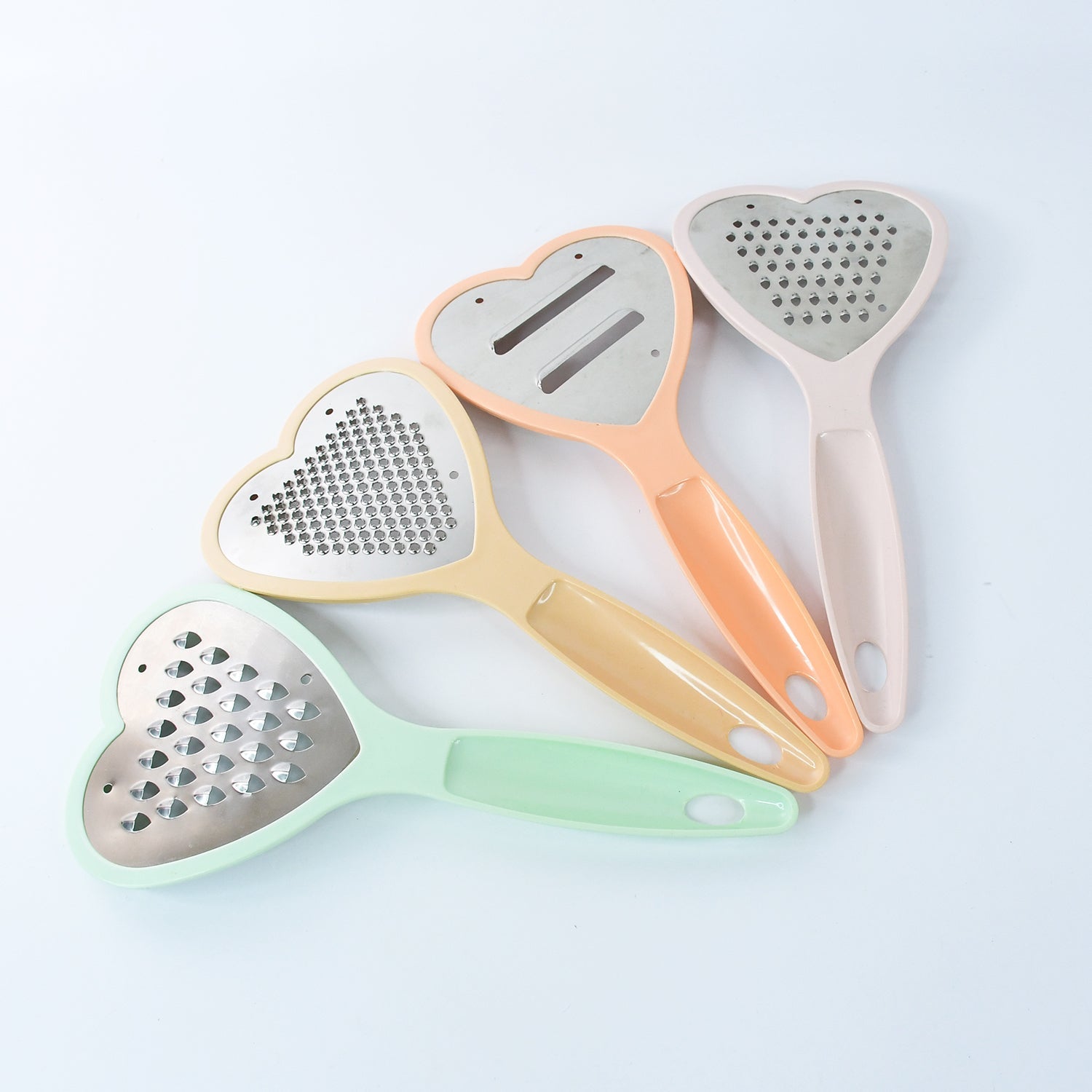 The complete set of heart grater and slicer tools displayed in a modern kitchen setting.