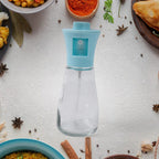 Fine mist spray from the oil dispenser bottle evenly coating food during cooking.