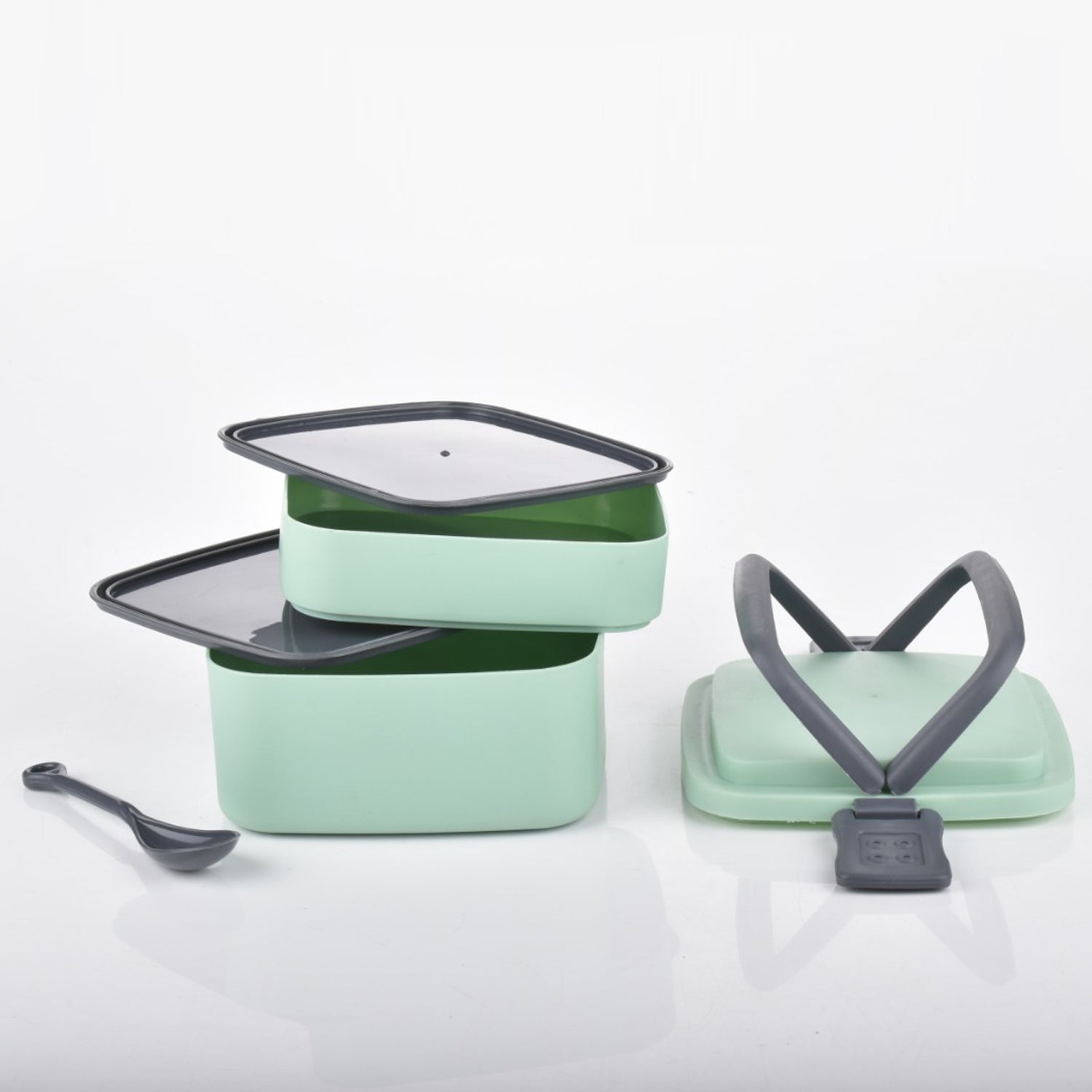 Green plastic bento box with a secure locking system.