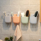 Mobile holder attached to wall socket for charging and accessory storage