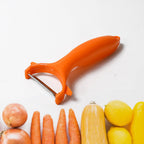 A hand demonstrating the vegetable peeler from the kitchen tool set.
