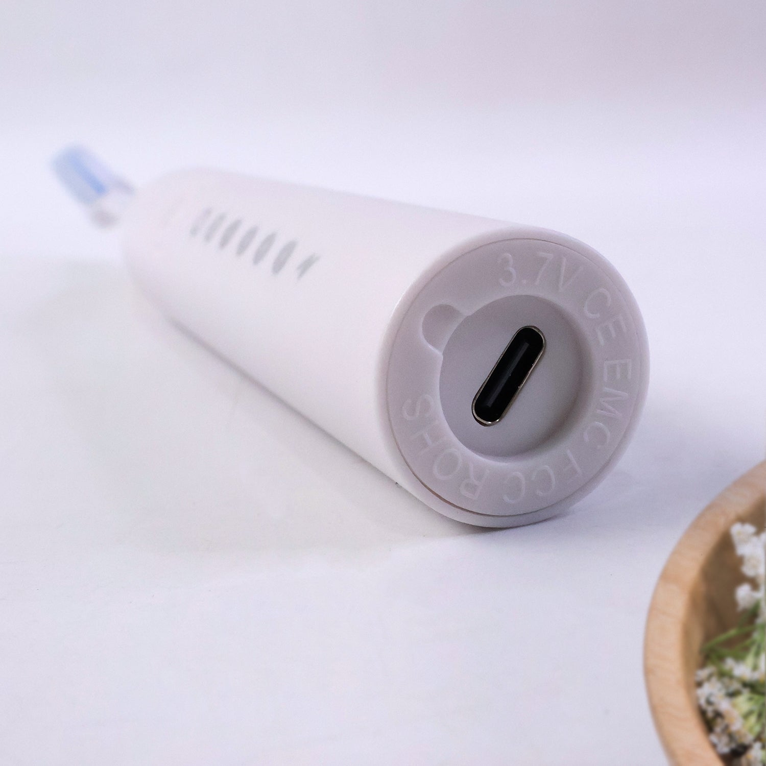 Close detail of ergonomic handle on rechargeable electric toothbrush