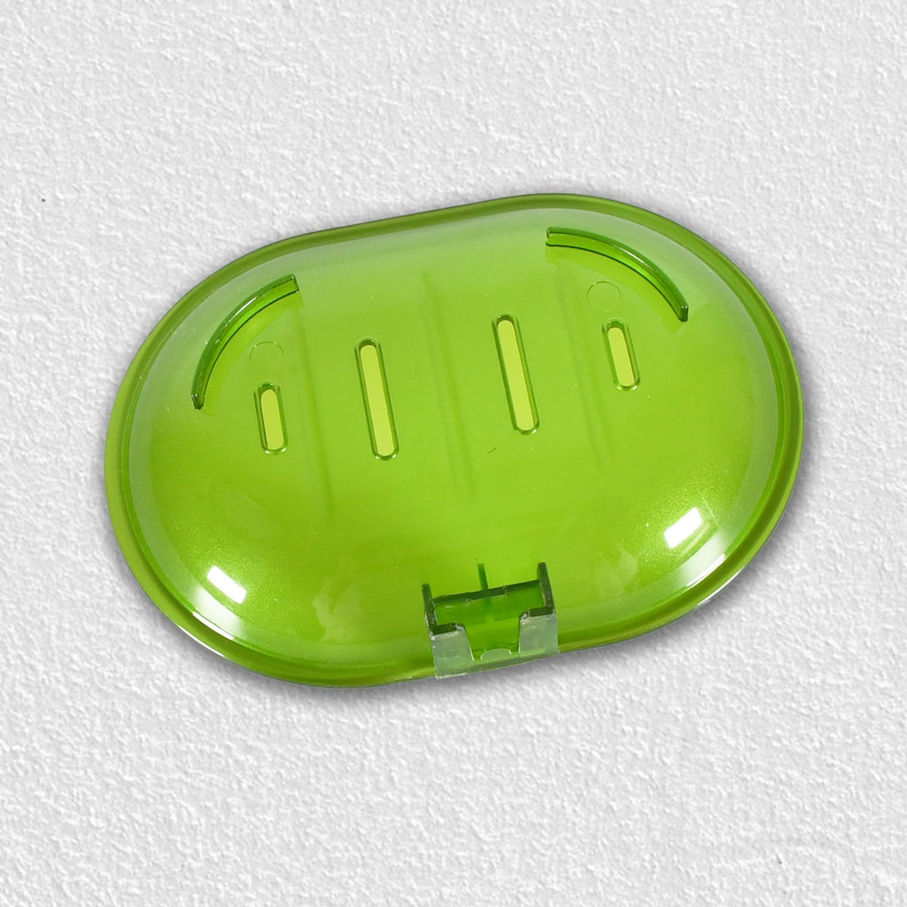 Plastic soap dish holder securely attached to a ceramic tile wall.