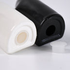 Two ceramic shakers, black and white, hugging as couple design