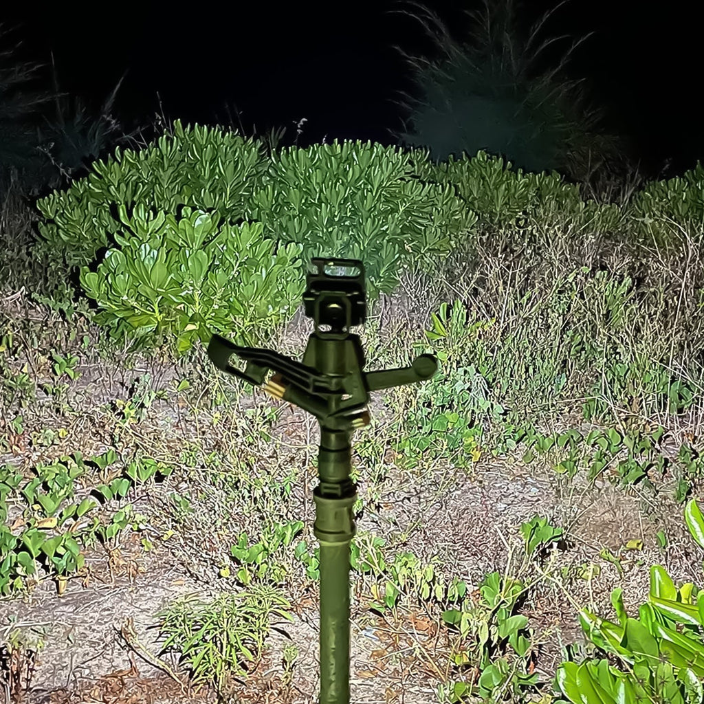 Person using a compact keychain flashlight for outdoor activities