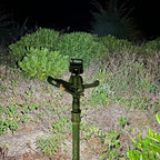 Person using a compact keychain flashlight for outdoor activities