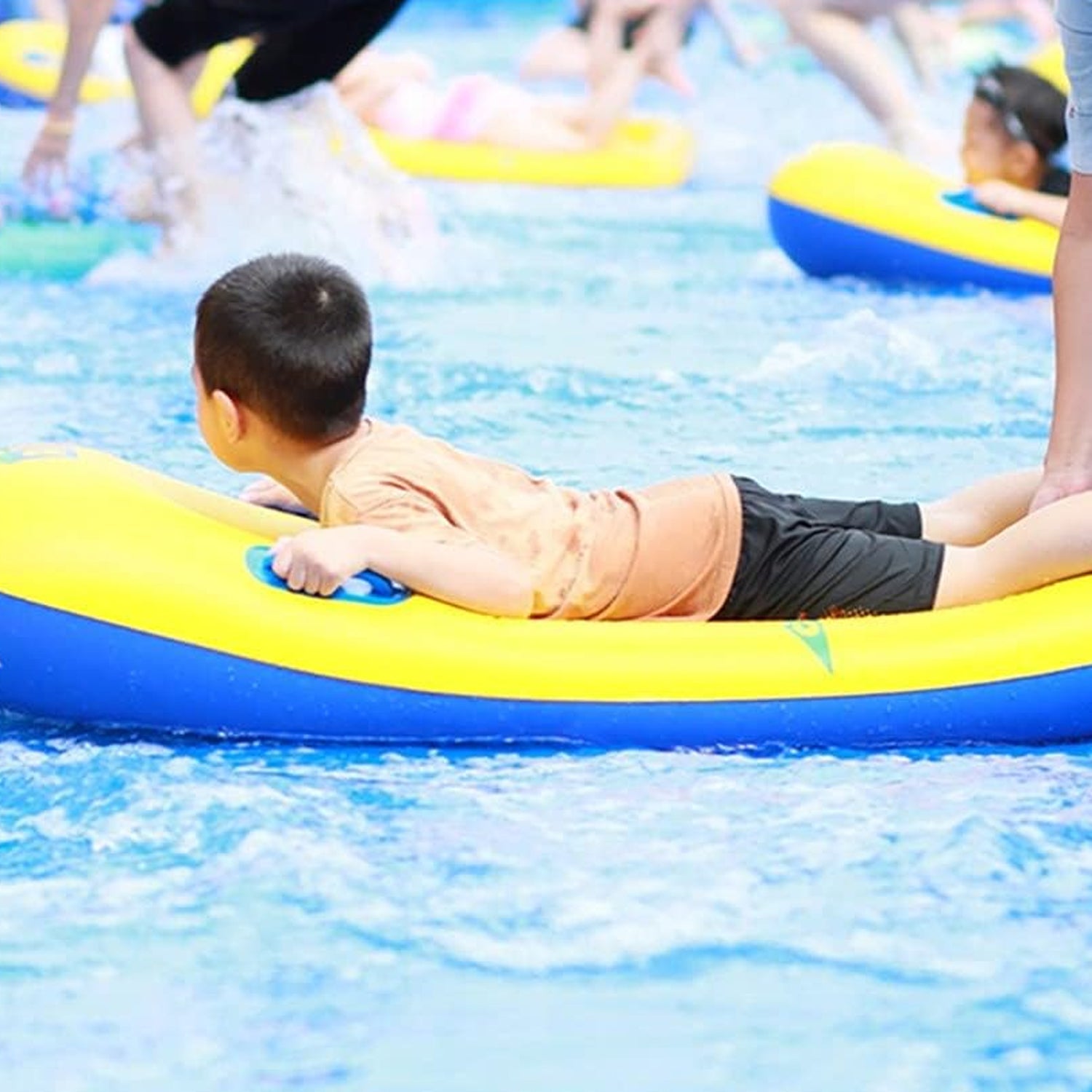 A child peering through the transparent window of a blue inflatable surf board.