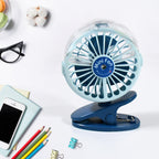 A person using the  rechargeable mini fan for personal cooling on a desk.