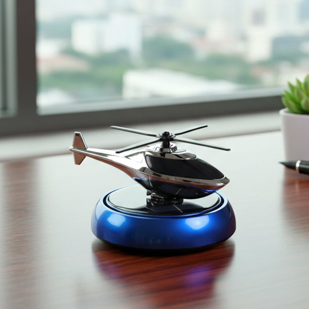 Compact car freshener with helicopter design rotating in sunlight