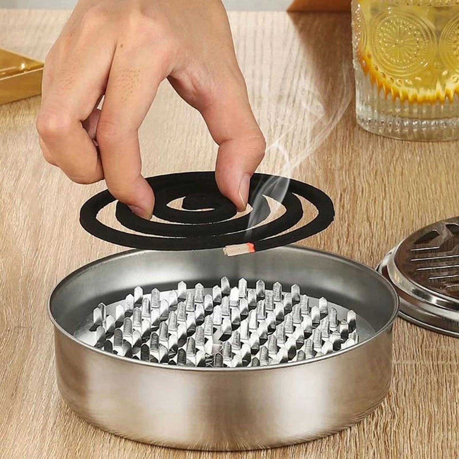 Ash tray base in mosquito coil stand collecting ash and preventing mess