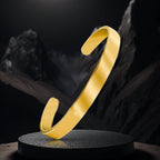 Radiant loop designer gold Kada bracelet with polished metal surface