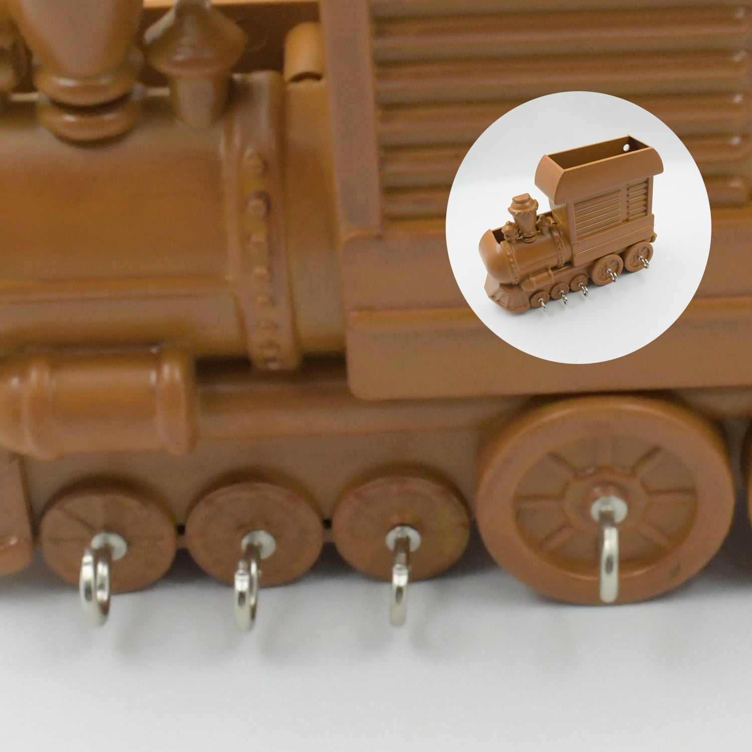Angled view of the decorative train key holder with hooks.