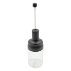 The sleek design of the Heat-Resistant Glass Seasoning Jar on a kitchen counter.
