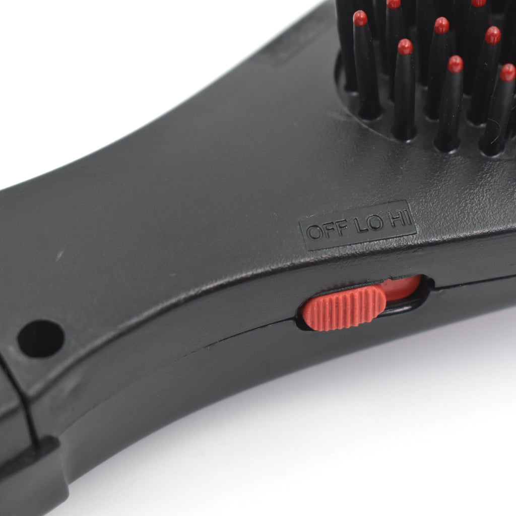 Detailed view of the electric hair massager comb's ergonomic design.