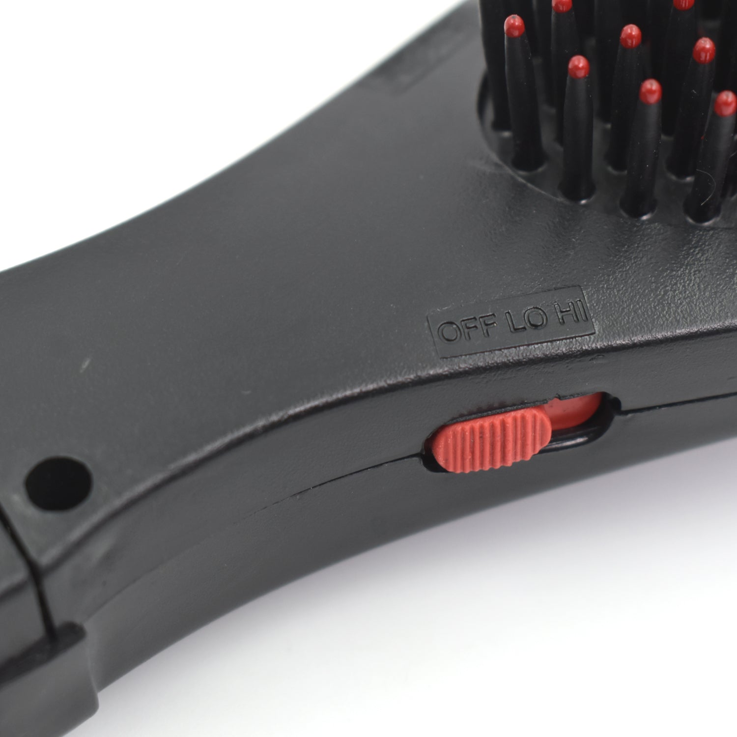 Detailed view of the electric hair massager comb's ergonomic design.