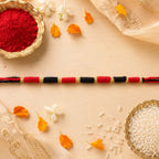 Closeup of handcrafted Rakhi with golden accents