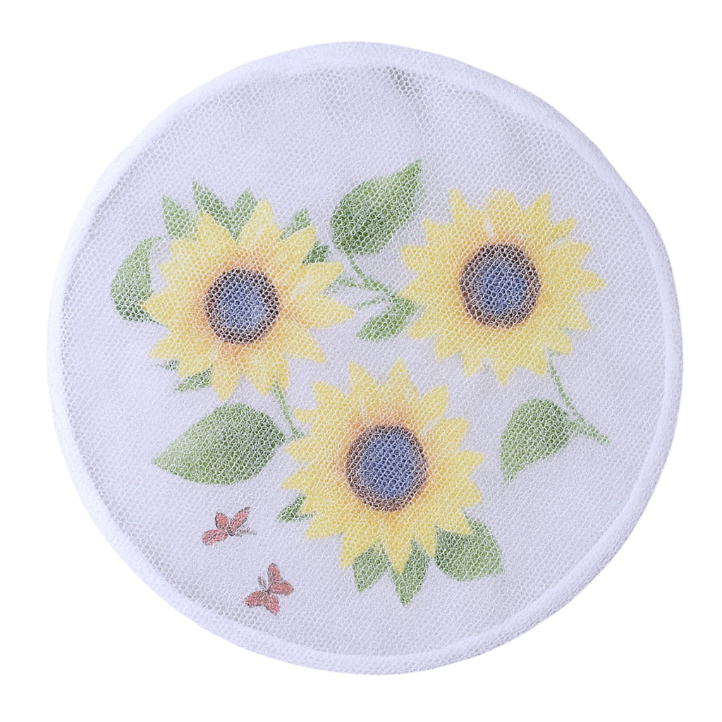 Decorative sunflower mesh fan cover placed on a table fan