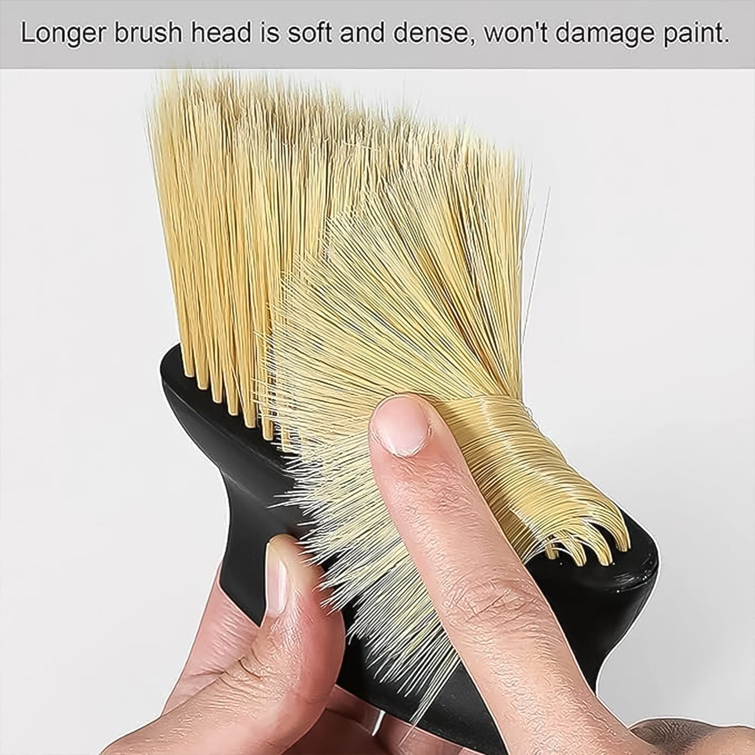 Ergonomic cleaning brush easily dusting a car's air outlet, showing its comfortable grip and effective reach.