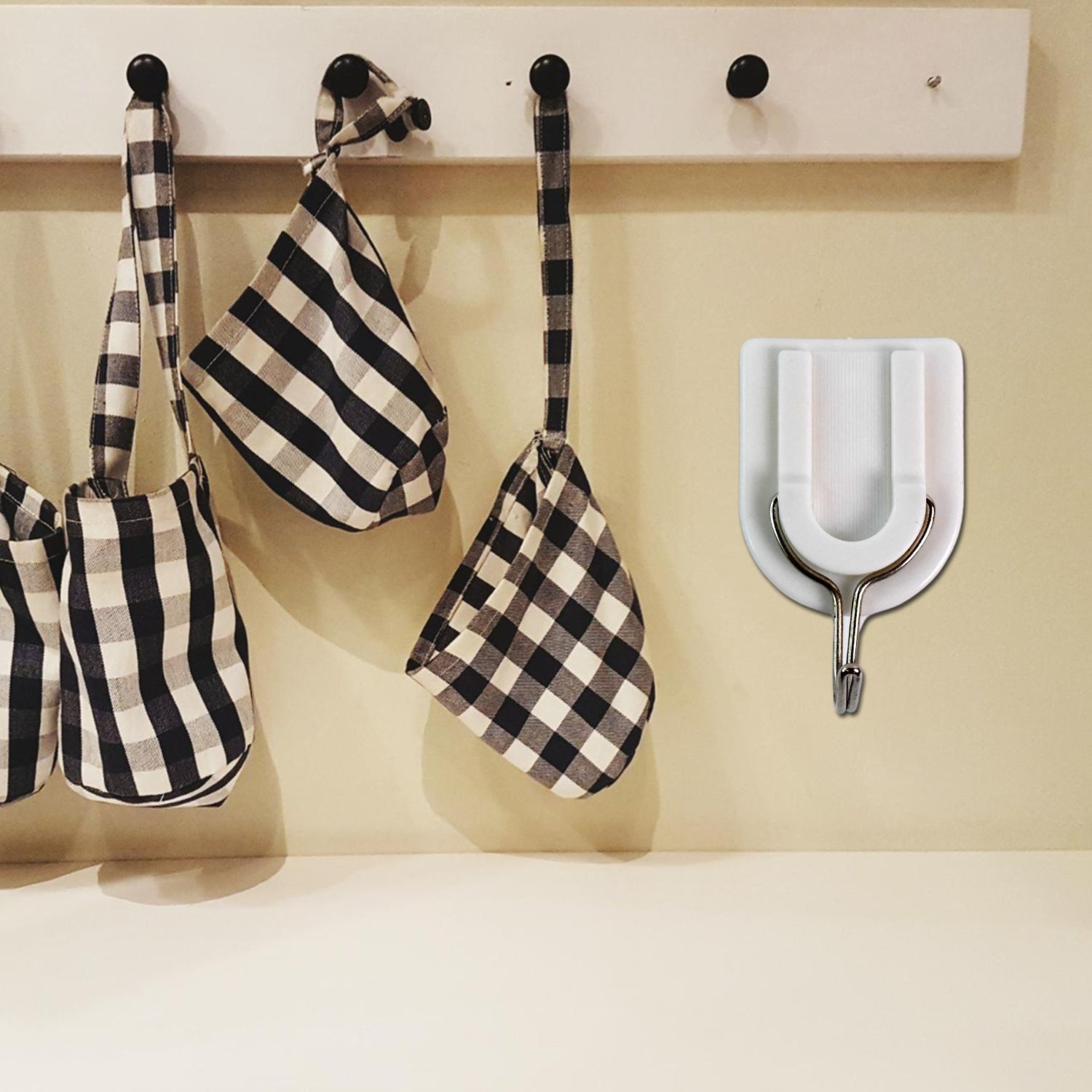 Practical adhesive wall hook holding a small purse, demonstrating its versatile use.