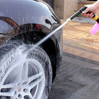 Hand rotating the multi-mode brass spray gun nozzle to select different water patterns.