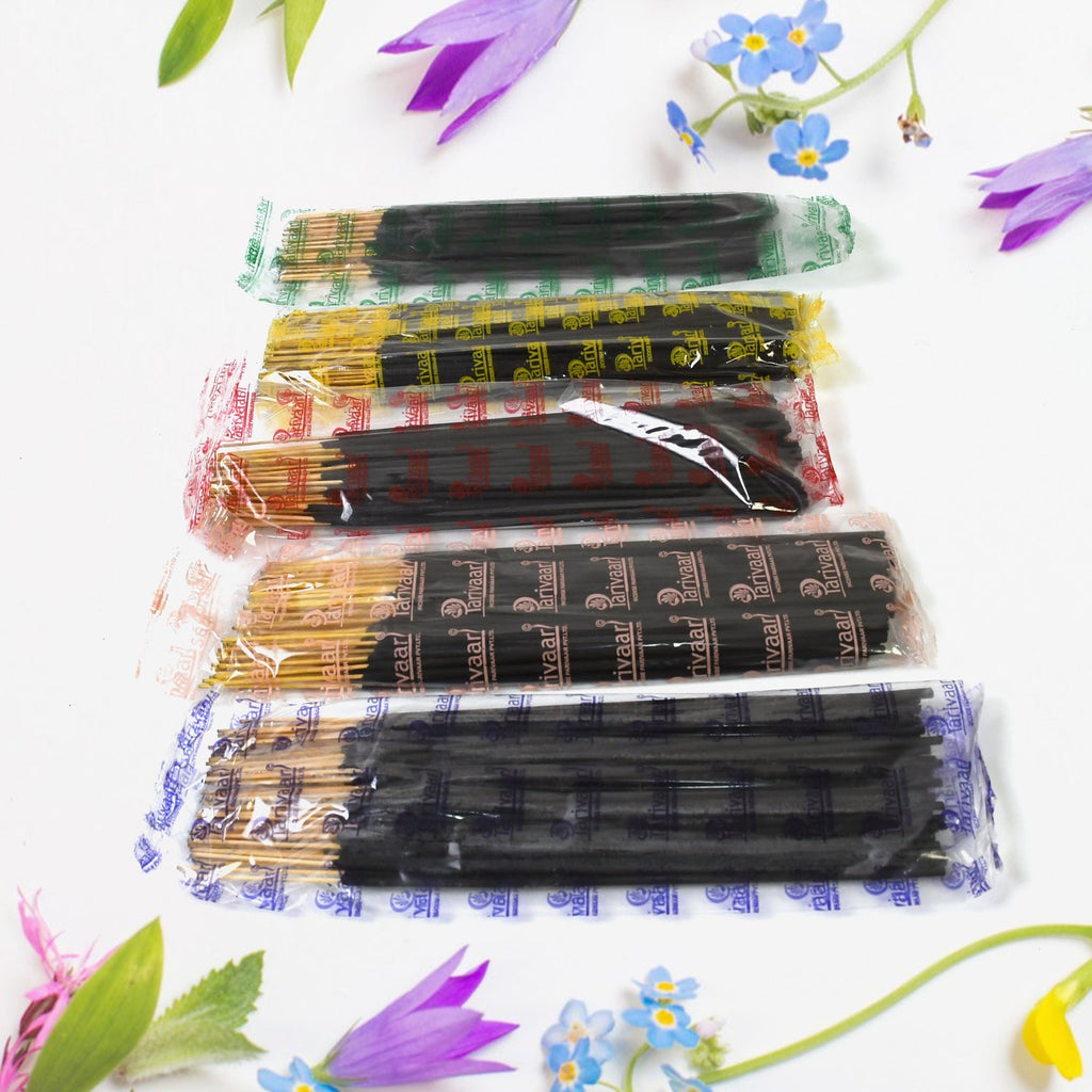 Lit  Pancham incense stick releasing fragrant smoke, creating a calming atmosphere.