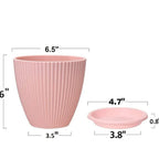 Multiple black plastic flower pots displayed from various angles to show the full set.