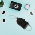 A hand holding the small retractable cable lock, illustrating its convenient size for daily carry.