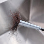 Spring drain cleaner removing hair clog from sink pipe