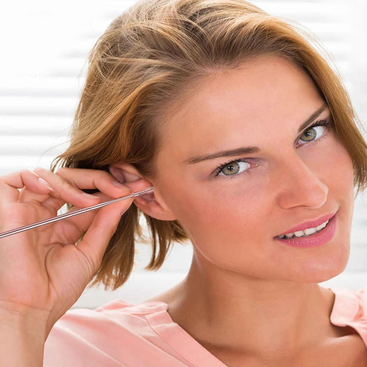 Compact keychain holder securely storing the ear cleaning tools for on-the-go hygiene.